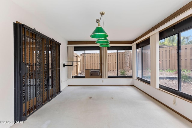 unfurnished sunroom with baseboards, cooling unit, and carpet floors
