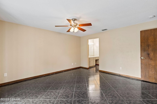 unfurnished room with a ceiling fan, dark tile patterned floors, baseboards, and visible vents