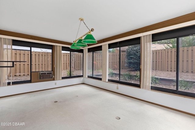 unfurnished sunroom with cooling unit, carpet floors, and baseboards