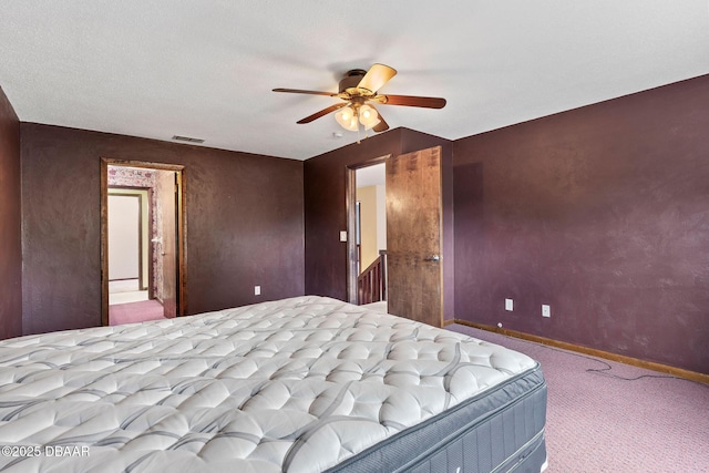carpeted bedroom featuring a ceiling fan, baseboards, and visible vents