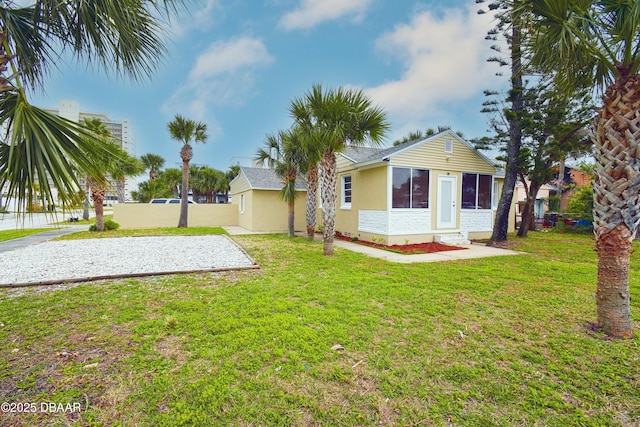 rear view of property with a lawn