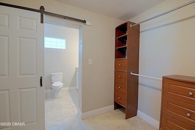 walk in closet with a barn door