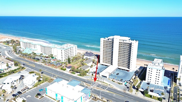 bird's eye view featuring a water view and a beach view