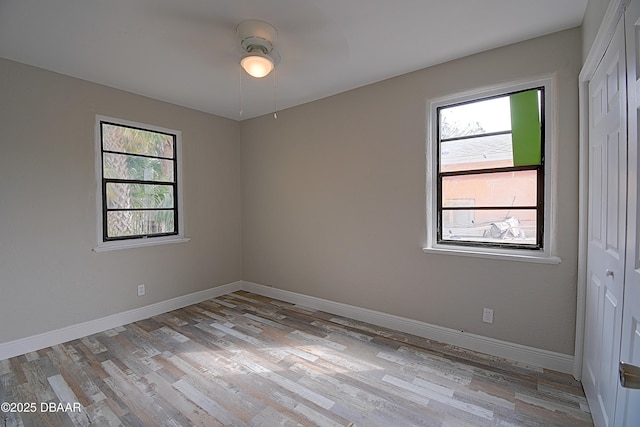 spare room with a healthy amount of sunlight and light hardwood / wood-style floors