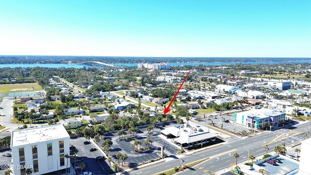 drone / aerial view featuring a water view and a beach view