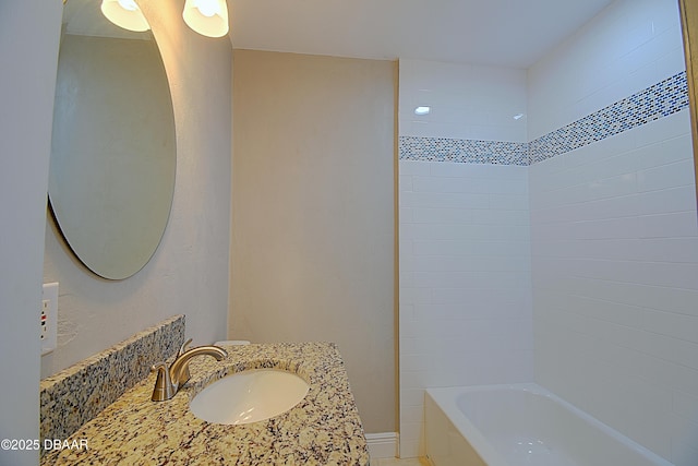 bathroom featuring sink and tiled shower / bath