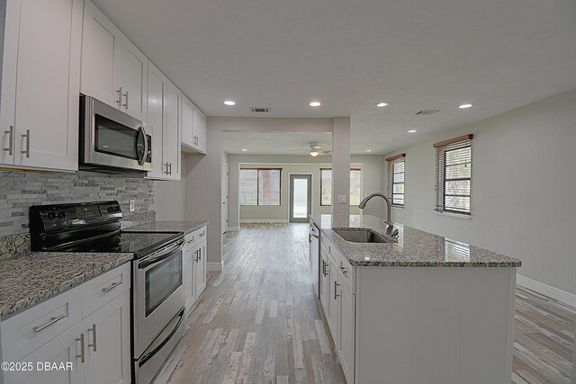 spare room with light hardwood / wood-style floors and ceiling fan