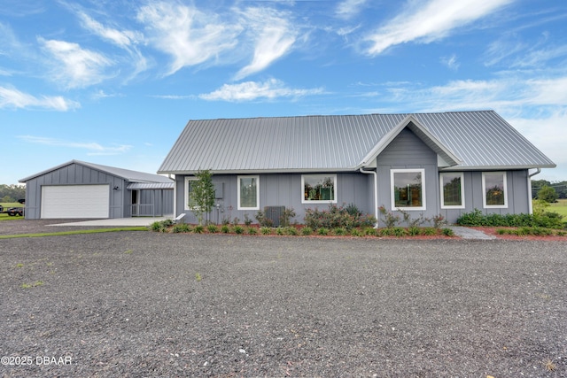 ranch-style house featuring a garage and central AC unit