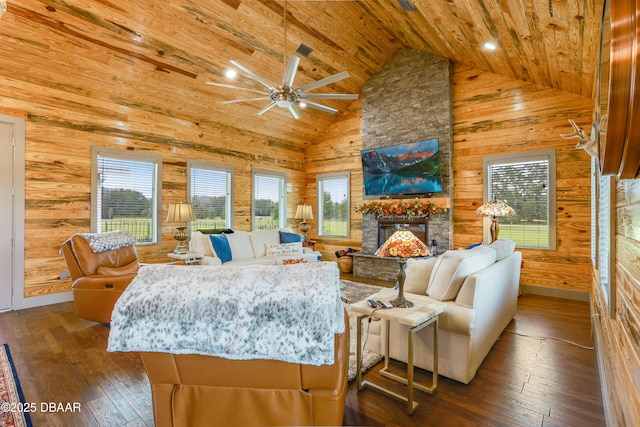 living room with wooden walls, high vaulted ceiling, dark hardwood / wood-style floors, and plenty of natural light