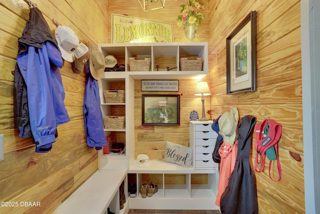 mudroom featuring wooden walls