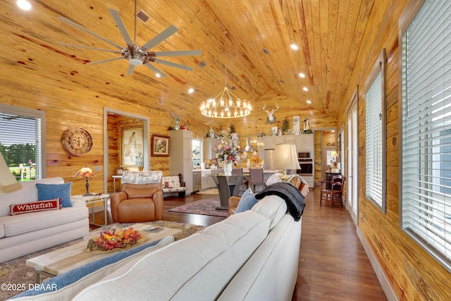 living room with a healthy amount of sunlight, wooden walls, and wooden ceiling