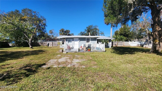 rear view of house with a yard