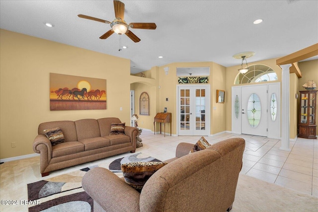 living room featuring light tile patterned floors, french doors, decorative columns, and ceiling fan