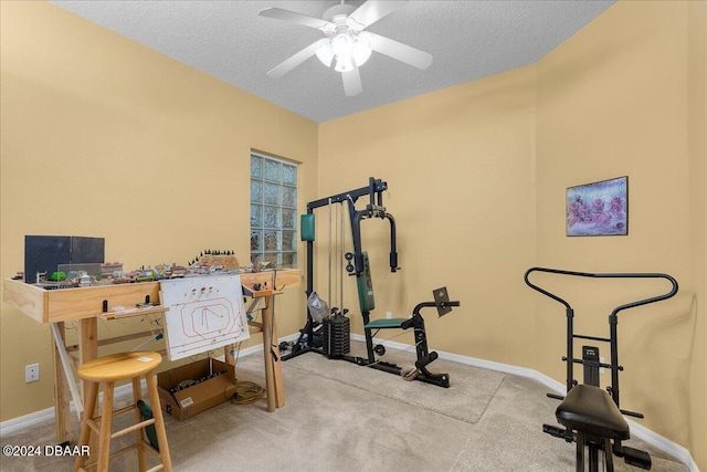 workout area with ceiling fan, carpet floors, and a textured ceiling