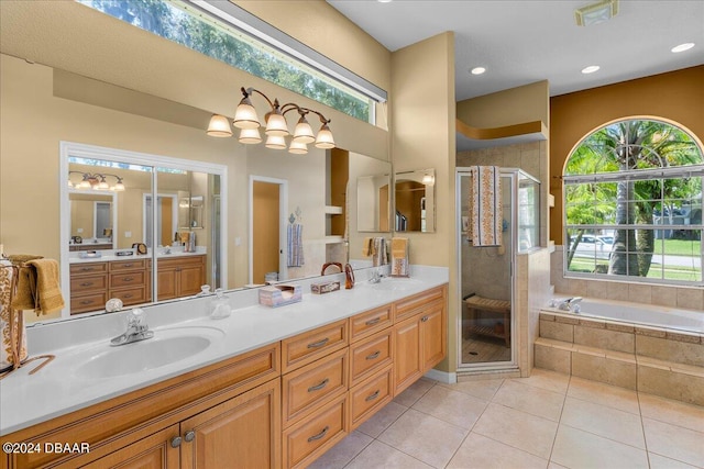 bathroom featuring tile patterned flooring, plenty of natural light, separate shower and tub, and vanity