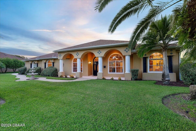 mediterranean / spanish home featuring a yard