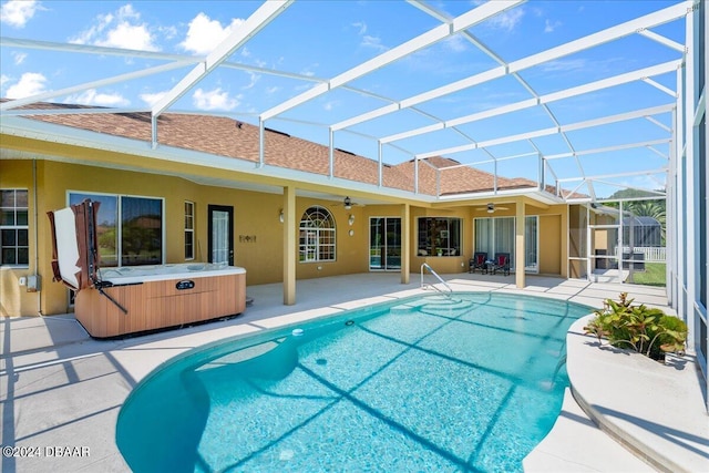 view of swimming pool with a lanai, a patio area, ceiling fan, and a hot tub