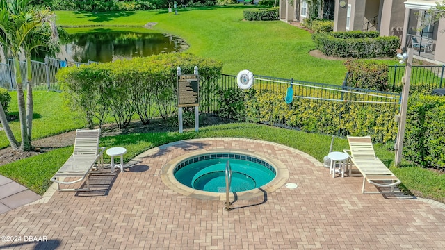 view of pool with a lawn, a community hot tub, a water view, and a patio area