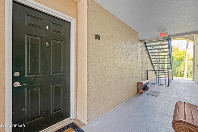 940 Village Trl Unit 6-102, Port Orange, FL 32127 - doorway to property with stucco siding and a porch