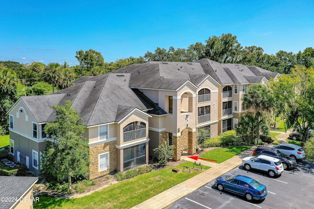 940 Village Trl Unit 6-102, Port Orange, FL 32127 - view of building exterior with uncovered parking