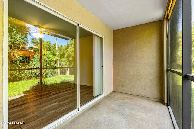 unfurnished sunroom featuring ceiling fan