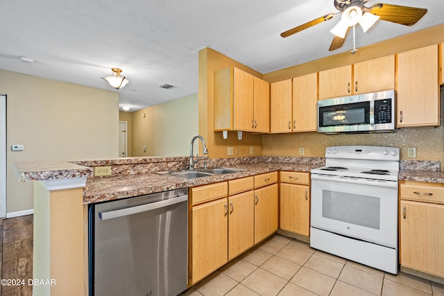 kitchen featuring stainless steel appliances, kitchen peninsula, sink, light tile patterned flooring, and light brown cabinetry