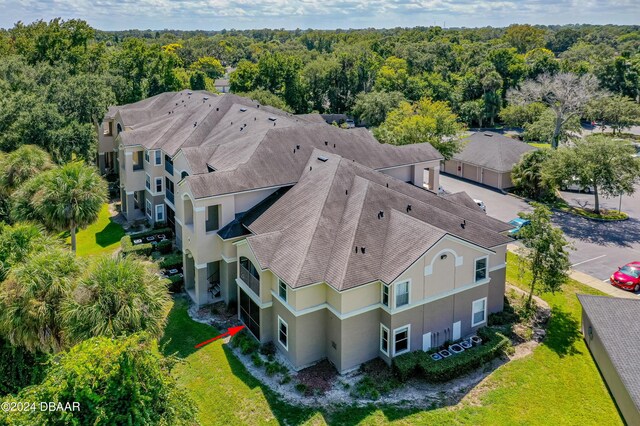 940 Village Trl Unit 6-102, Port Orange, FL 32127 - aerial view of property and surrounding area featuring a forest