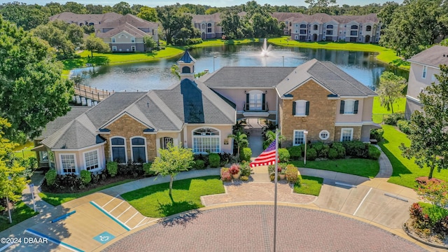 940 Village Trl Unit 6-102, Port Orange, FL 32127 - colonial home featuring a water view, stucco siding, a front yard, and a residential view