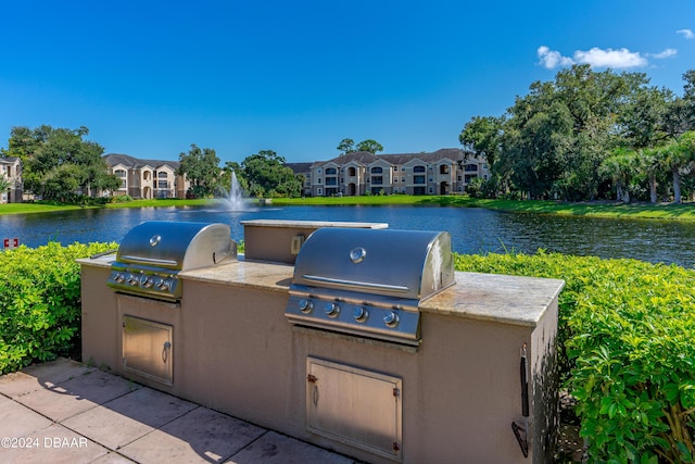 940 Village Trl Unit 6-102, Port Orange, FL 32127 - view of patio / terrace featuring a grill, area for grilling, and a water view