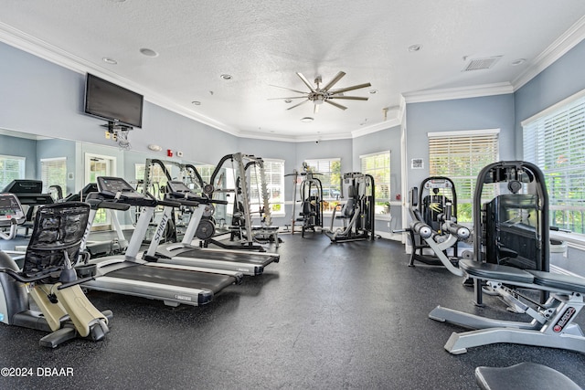 workout area featuring a textured ceiling, crown molding, and ceiling fan