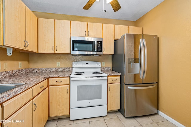 940 Village Trl Unit 6-102, Port Orange, FL 32127 - kitchen with appliances with stainless steel finishes, light brown cabinets, a ceiling fan, light tile patterned floors, and a sink
