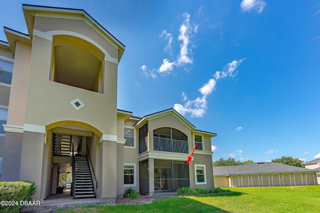 back of property with a lawn