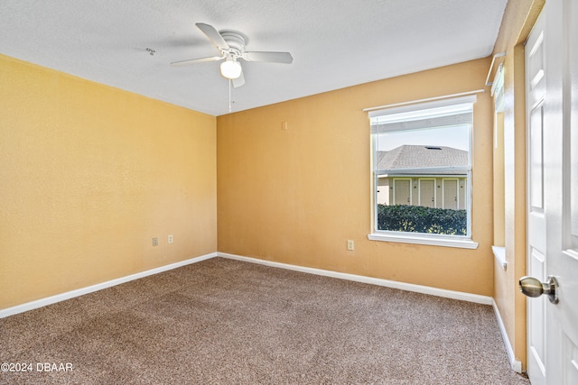 spare room with ceiling fan, a textured ceiling, and carpet floors