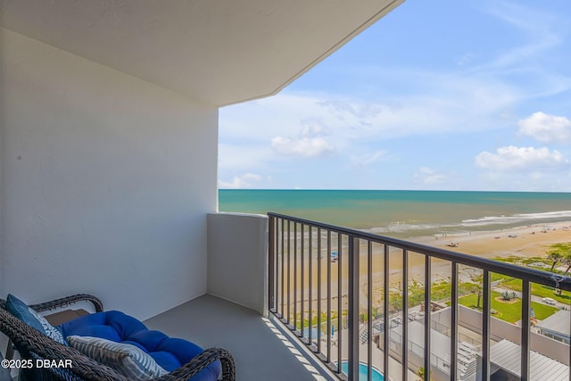 balcony with a water view and a beach view