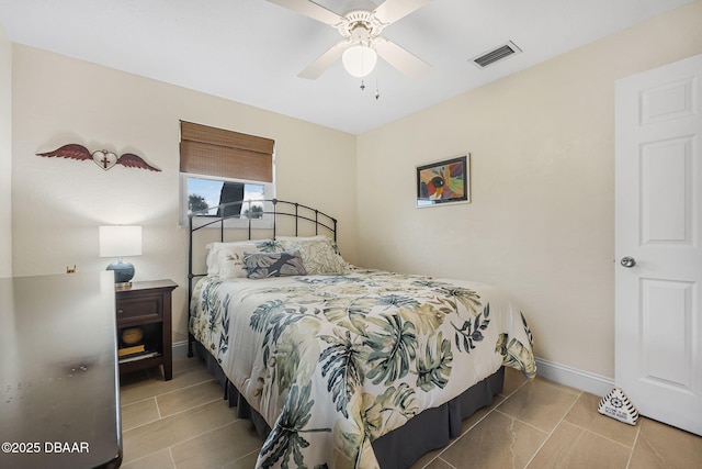 tiled bedroom with ceiling fan