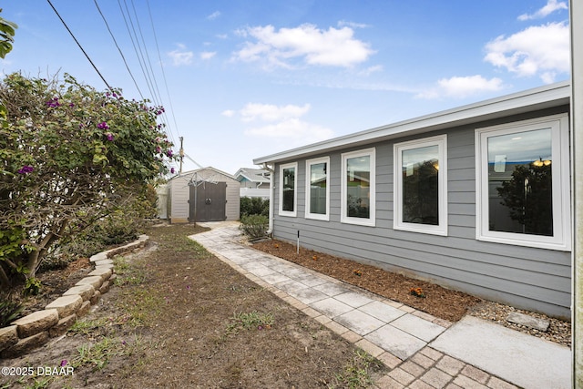 view of side of home featuring a storage unit