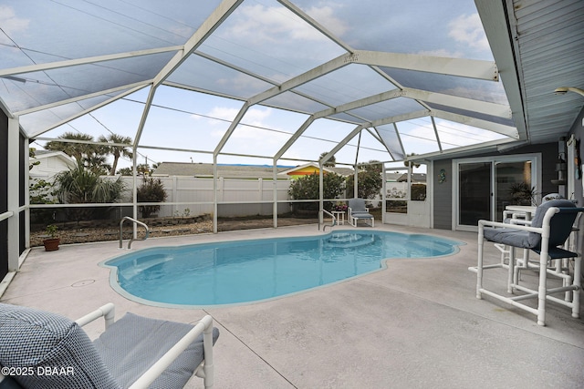 view of swimming pool with a patio and glass enclosure