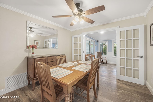 dining space featuring crown molding, dark wood-type flooring, french doors, and ceiling fan