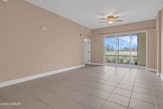 unfurnished room with ceiling fan and light tile patterned flooring