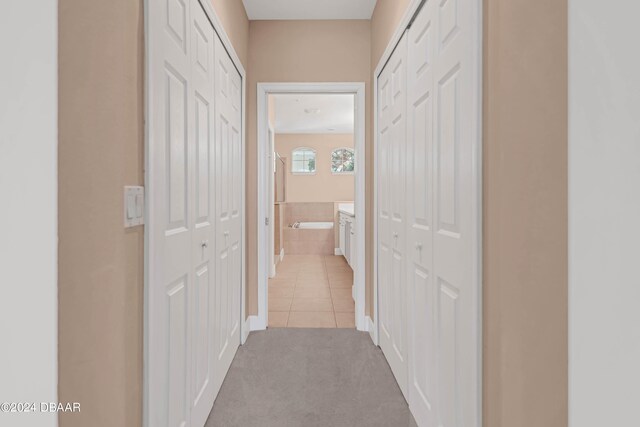 corridor featuring light tile patterned floors