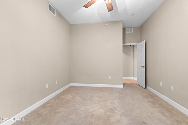 unfurnished bedroom featuring light carpet and ceiling fan