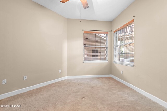 carpeted empty room featuring ceiling fan