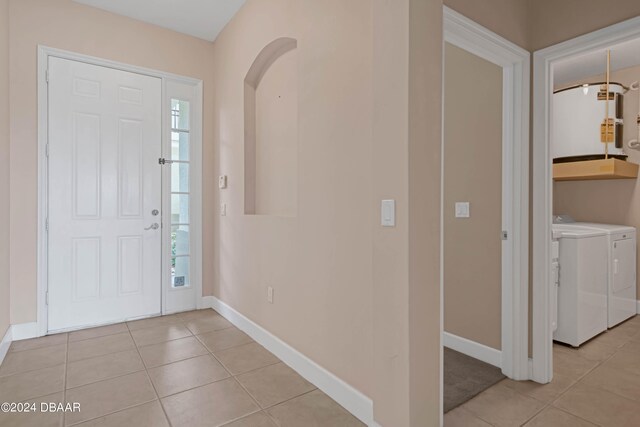 tiled entryway featuring washing machine and dryer