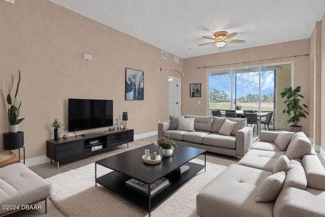 tiled living room featuring ceiling fan