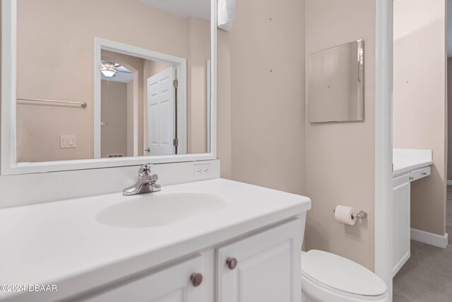 bathroom featuring toilet and vanity