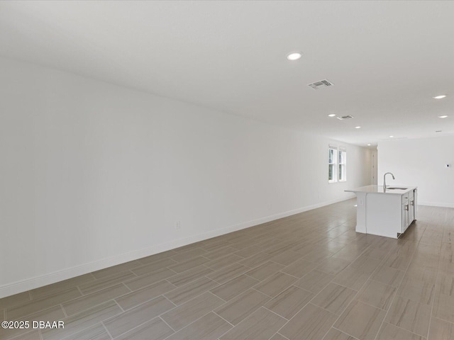 173 Links Terrace Blvd, Daytona Beach, FL 32124 - empty room with recessed lighting, a sink, baseboards, and light wood-style floors