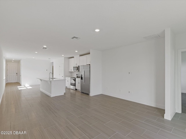 173 Links Terrace Blvd, Daytona Beach, FL 32124 - unfurnished living room featuring a sink, baseboards, recessed lighting, and light wood-style flooring