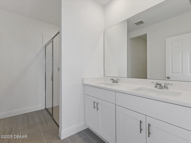 173 Links Terrace Blvd, Daytona Beach, FL 32124 - bathroom with double vanity, a stall shower, and baseboards