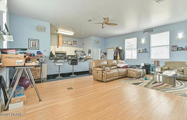 830 S Peninsula Dr, Daytona Beach, FL 32118 - living room featuring a ceiling fan and light wood-style flooring