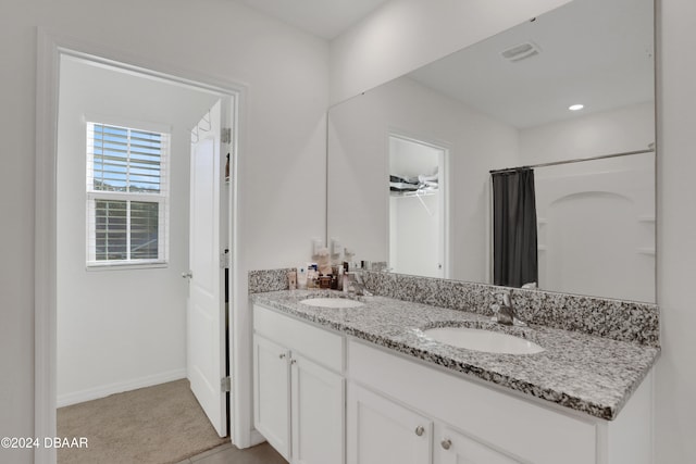 bathroom with a shower with curtain and vanity